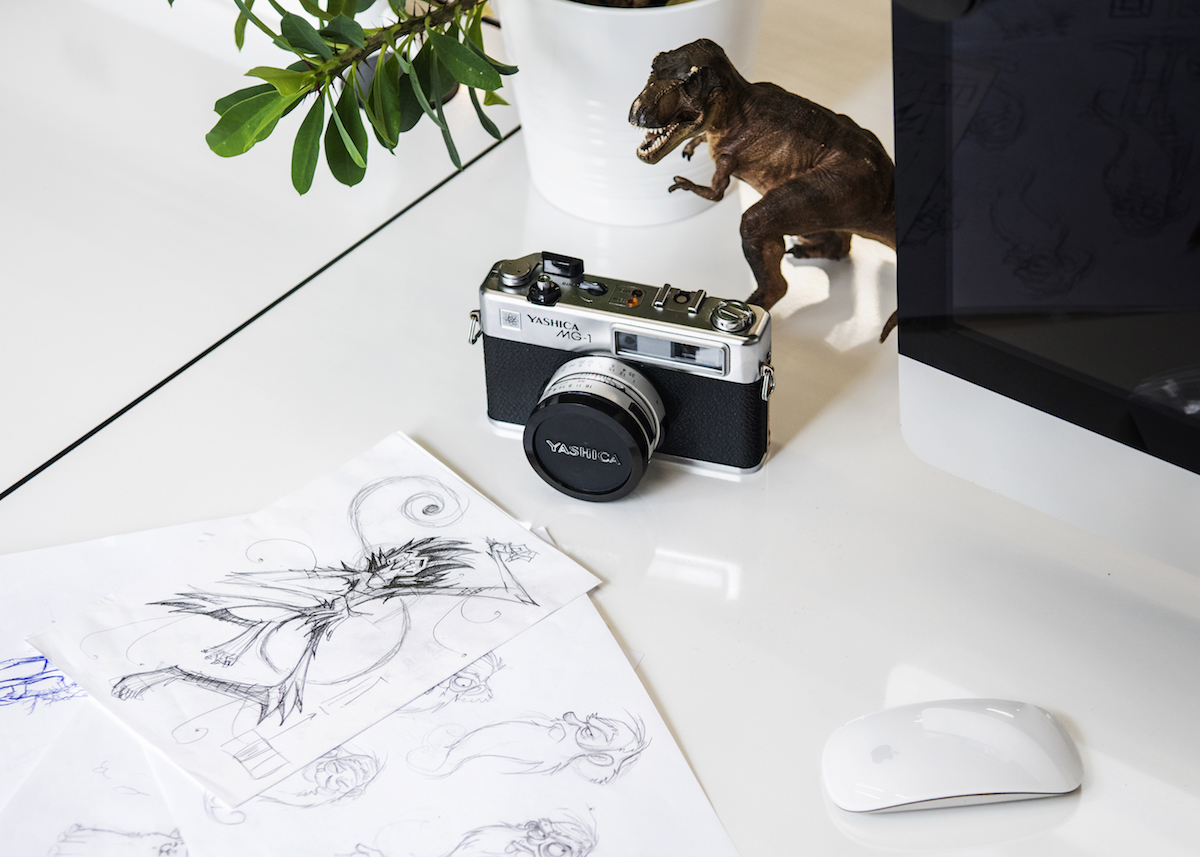 A dinosaur toy, sketches and a camera in Despark office