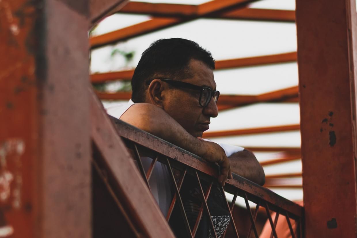 Despark - Photo by Chirag Saini on Unsplash Man leaning on bridge - Despark on constraints in digital transformation